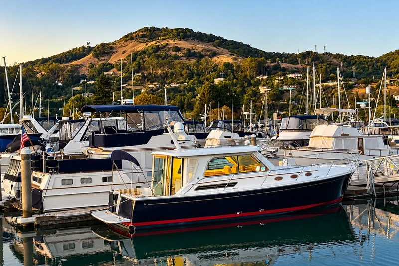 Slide: The Image of 2011 Back Cove 37 yacht docked in scenic marina with hills in background. - 5