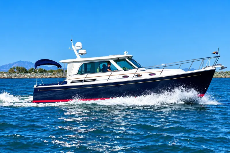 Slide: The Image of 2011 Back Cove 37 yacht cruising on blue ocean waters under clear skies. - 1