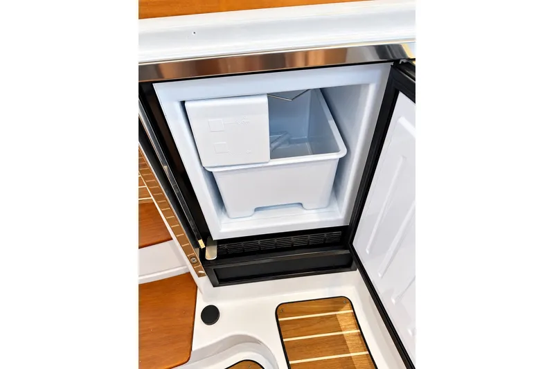 Slide: The Image of Open refrigerator on 2011 Back Cove 37 boat, showcasing interior storage space. - 26