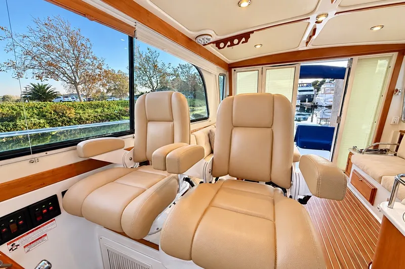 Slide: The Image of Luxurious interior of 2011 Back Cove 37 yacht with plush seating and scenic views. - 14