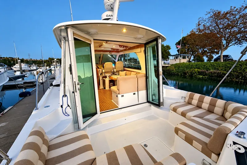 Slide: The Image of 2011 Back Cove 37 yacht interior with striped seating, docked at marina. - 7