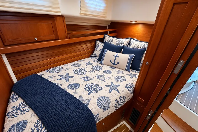 Slide: The Image of Cozy cabin interior of 2011 Back Cove 37 with nautical-themed bedding and wooden accents. - 32