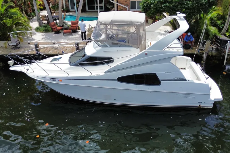 Slide: The Image of 2002 Silverton 330 Sport Bridge yacht docked by a tropical poolside. - 27