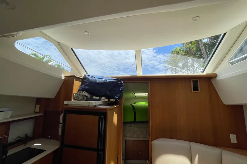 Slide: The Image of Interior view of 2002 Silverton 330 Sport Bridge with skylights and wooden cabinetry. - 33