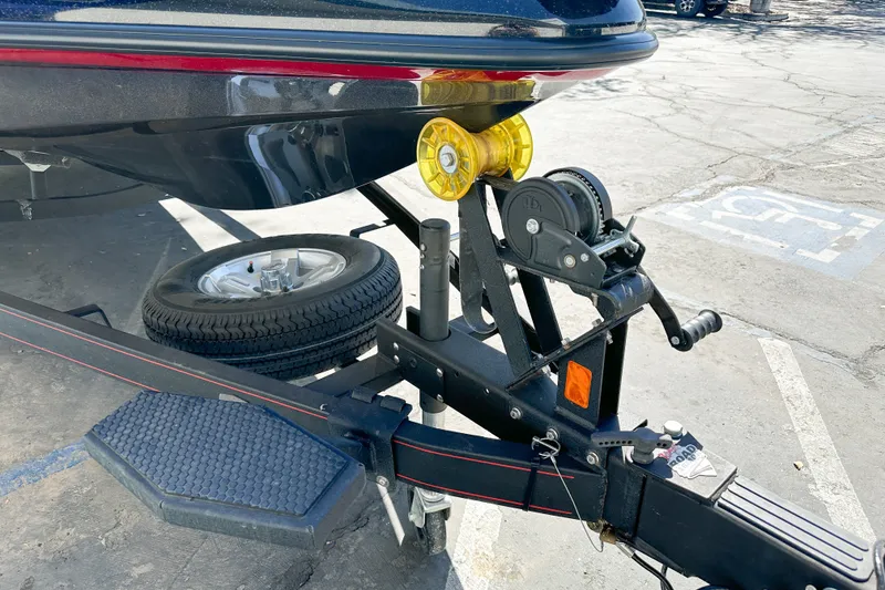Slide: The Image of Trailer hitch of 2025 Ranger Z185 boat with spare tire and winch in parking lot. - 3