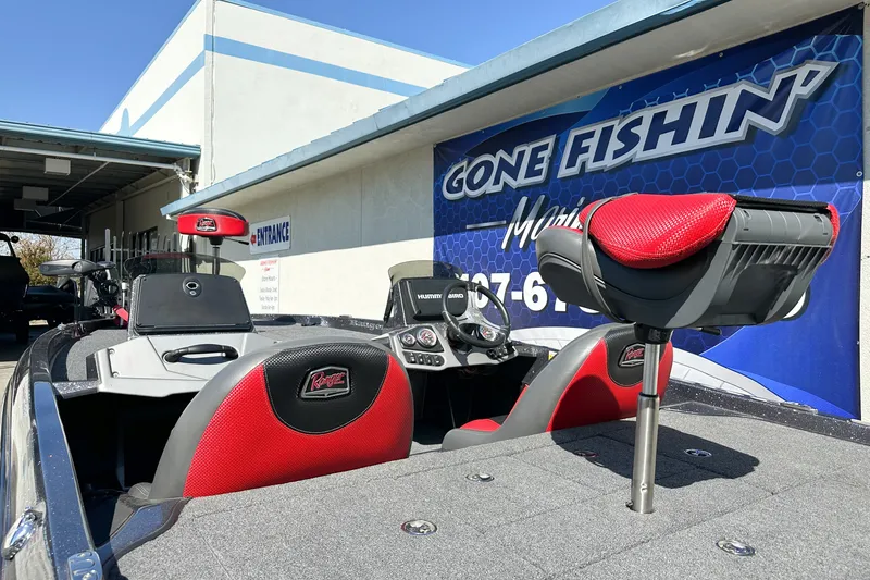 Slide: The Image of 2025 Ranger Z185 boat with red seats at "Gone Fishin'" marina entrance. - 5