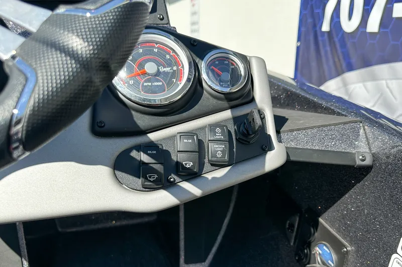 Slide: The Image of Dashboard of 2025 Ranger Z185 boat with gauges and control switches. - 11