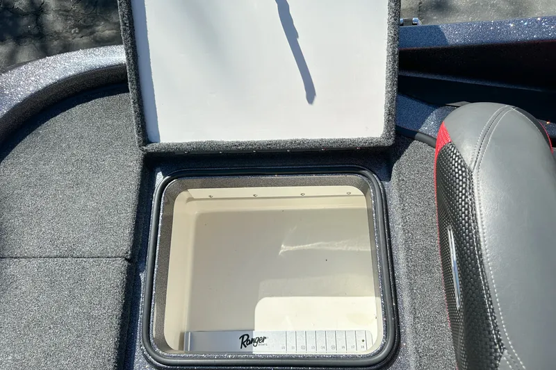 Slide: The Image of Open storage compartment in 2025 Ranger Z185 boat, featuring a sleek interior design. - 22