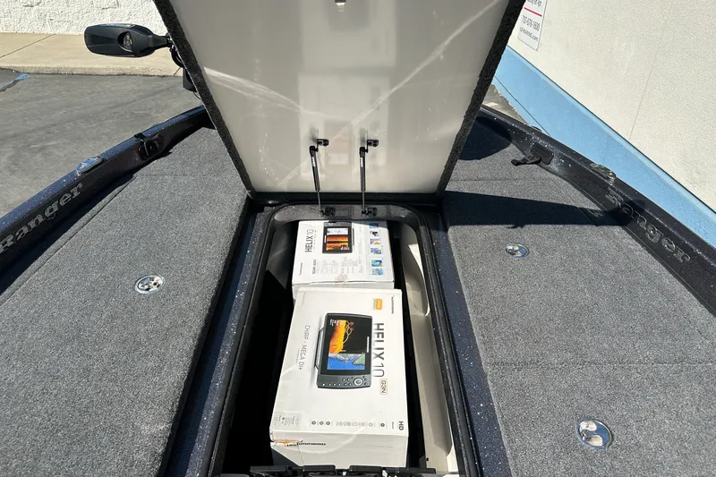 Slide: The Image of Open storage compartment in 2025 Ranger Z185 boat with electronics boxes inside. - 19