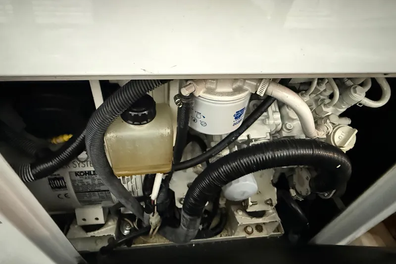 Slide: The Image of Engine compartment of a 2009 Harbor Master Coastal 520, featuring various hoses and components. - 9