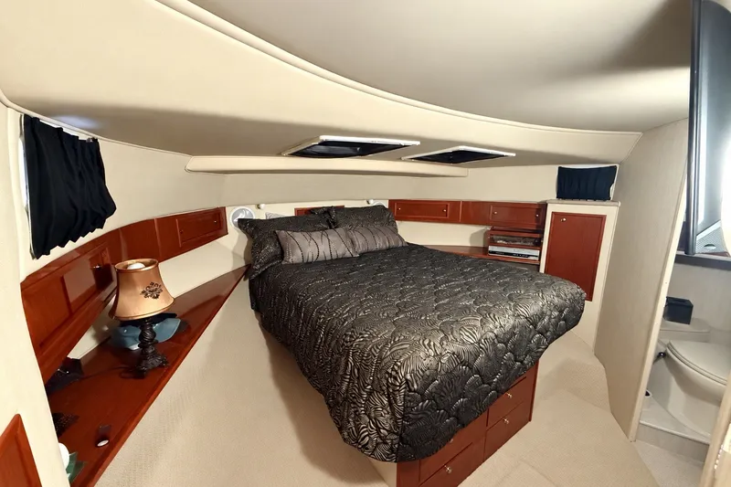 Slide: The Image of Luxurious bedroom interior of 2009 Harbor Master Coastal 520 yacht with elegant bedding and wood accents. - 4
