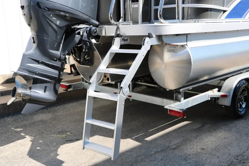 Slide: The Image of A 2027 Bennington 22 SFC Tri Toon with an outboard motor and aluminum ladder at the stern. - 23