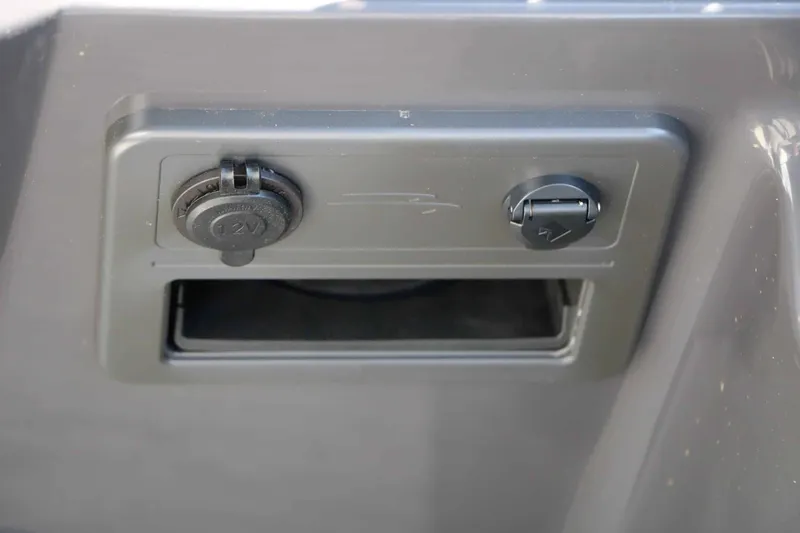 Slide: The Image of Close-up of a 12V outlet on a Bennington 22 SFC Tri Toon boat. - 38