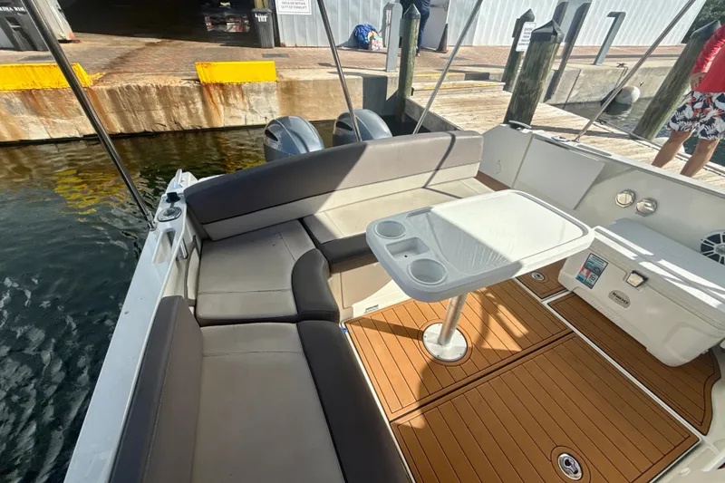 Slide: The Image of 2018 Jeanneau Cap Camarat 8.5 WA boat interior with seating and table at dock. - 7
