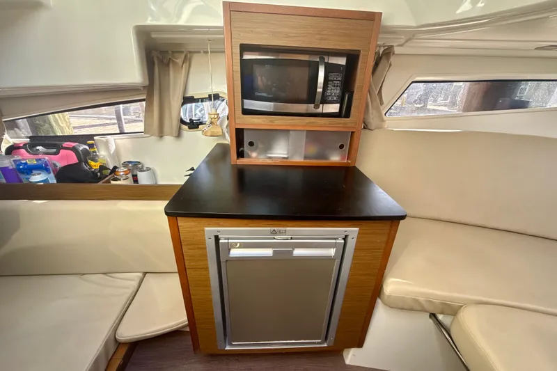 Slide: The Image of Interior of 2018 Jeanneau Cap Camarat 8.5 WA with kitchenette and seating area. - 16