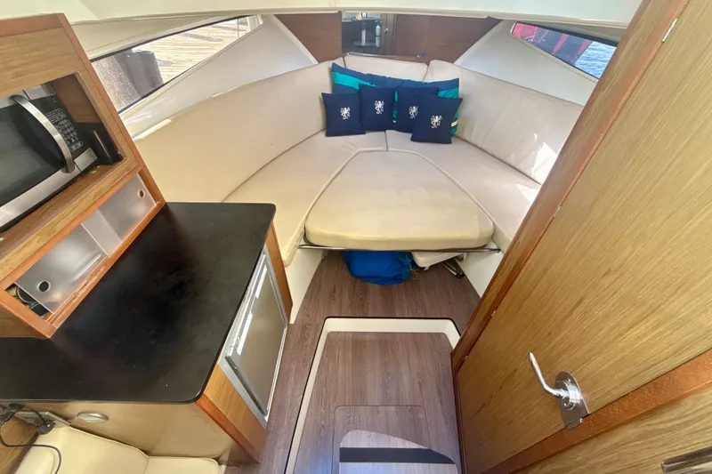Slide: The Image of Interior of 2018 Jeanneau Cap Camarat 8.5 WA boat with cozy seating and kitchenette. - 14
