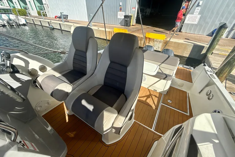 Slide: The Image of 2018 Jeanneau Cap Camarat 8.5 WA boat interior with dual seats and teak flooring. - 13