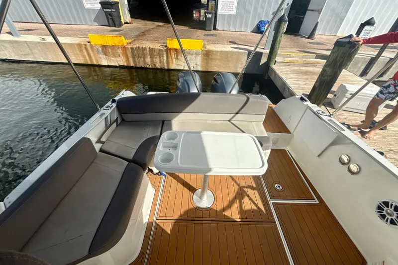 Slide: The Image of 2018 Jeanneau Cap Camarat 8.5 WA boat interior with seating and table at dock. - 8