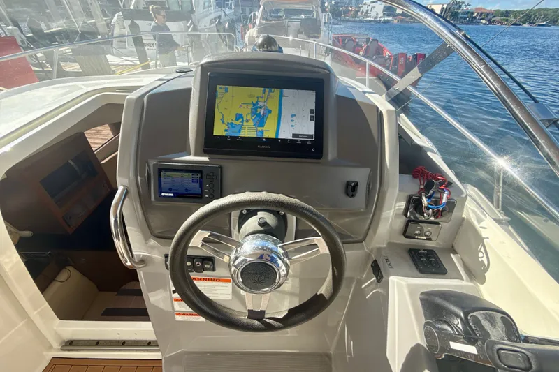 Slide: The Image of Cockpit view of 2018 Jeanneau Cap Camarat 8.5 WA with navigation screens and steering wheel. - 12