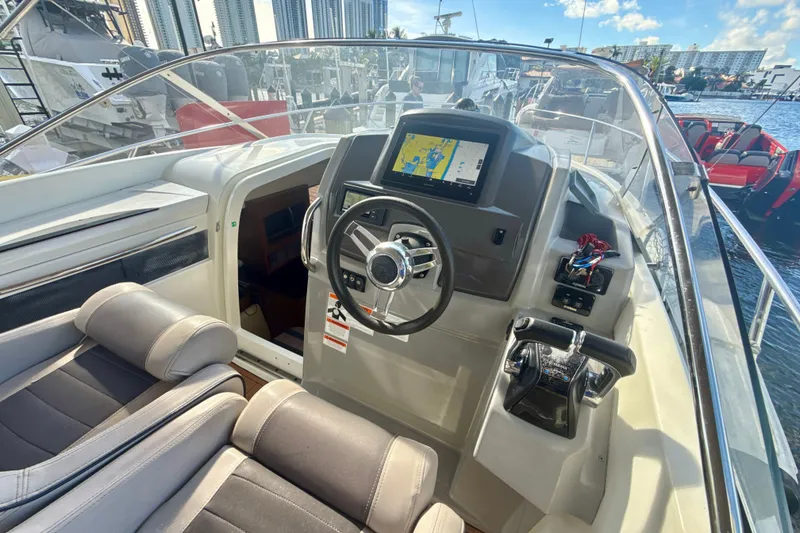 Slide: The Image of 2018 Jeanneau Cap Camarat 8.5 WA boat cockpit with steering wheel and navigation display. - 11