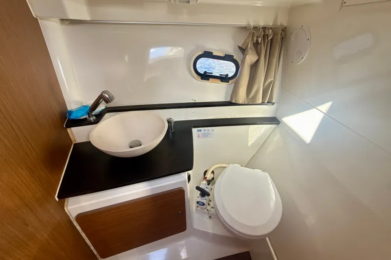 Slide: The Image of Compact bathroom in 2018 Jeanneau Cap Camarat 8.5 WA boat with sink and toilet. - 17