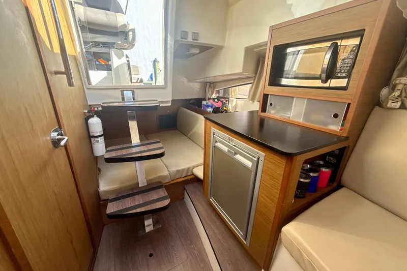 Slide: The Image of Interior of 2018 Jeanneau Cap Camarat 8.5 WA with kitchenette and seating area. - 18