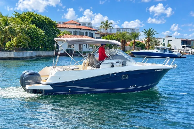 The Image of 2018 Jeanneau Cap Camarat 8.5 WA boat cruising on a sunny day near waterfront homes. - 1