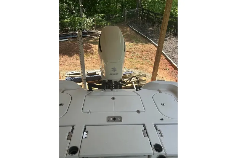 Slide: The Image of 2020 Blue Wave 2600 PureBay boat with Suzuki 300 outboard motor, parked outdoors. - 13