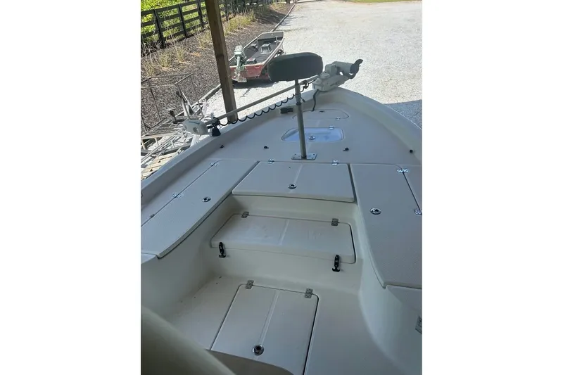 Slide: The Image of 2020 Blue Wave 2600 PureBay boat interior with storage compartments and fishing equipment. - 11