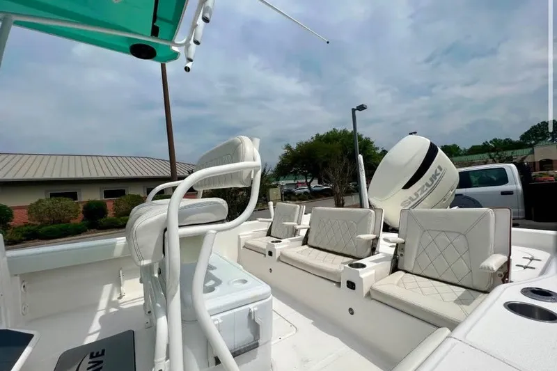 Slide: The Image of 2020 Blue Wave 2600 PureBay boat interior with seating and Suzuki engine. - 4