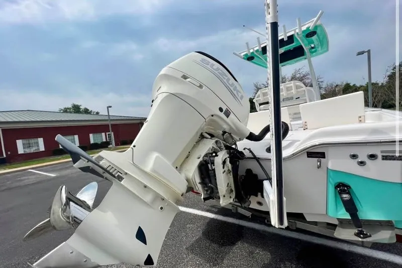 Slide: The Image of 2020 Blue Wave 2600 PureBay boat with powerful outboard motor in a parking lot. - 2