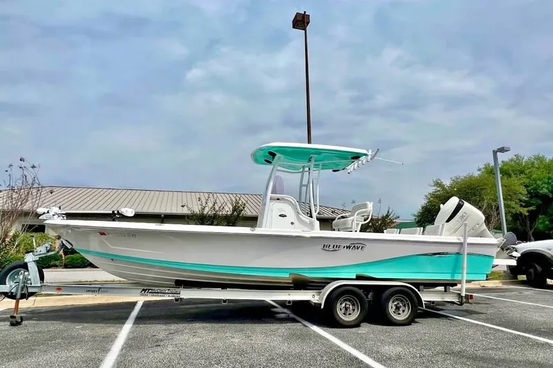 Slide: The Image of 2020 Blue Wave 2600 PureBay boat on trailer in parking lot. - 0