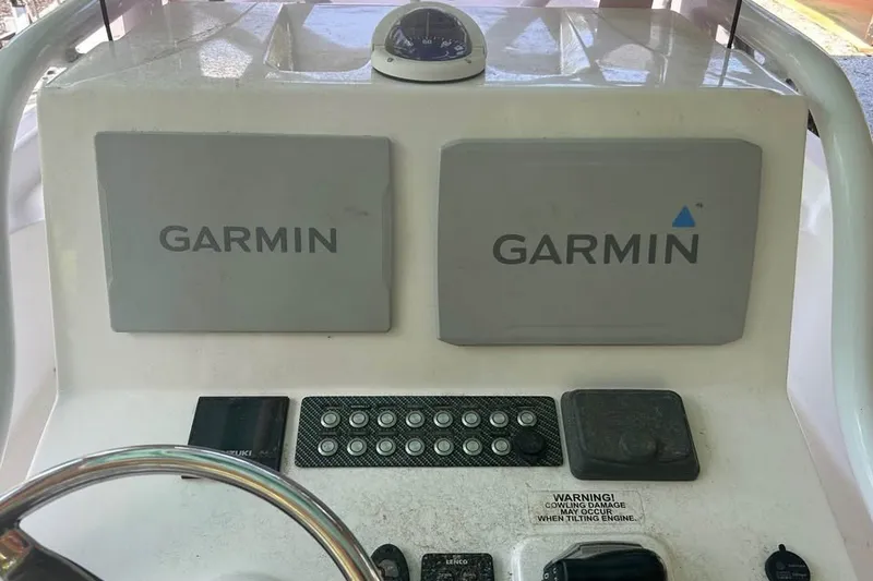 Slide: The Image of Dashboard of a 2020 Blue Wave 2600 PureBay boat featuring Garmin navigation systems. - 8
