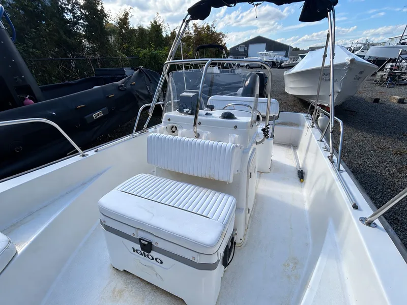 Slide: The Image of A 2007 Boston Whaler 17 Montauk with white interior and Igloo cooler on a gravel lot. - 3
