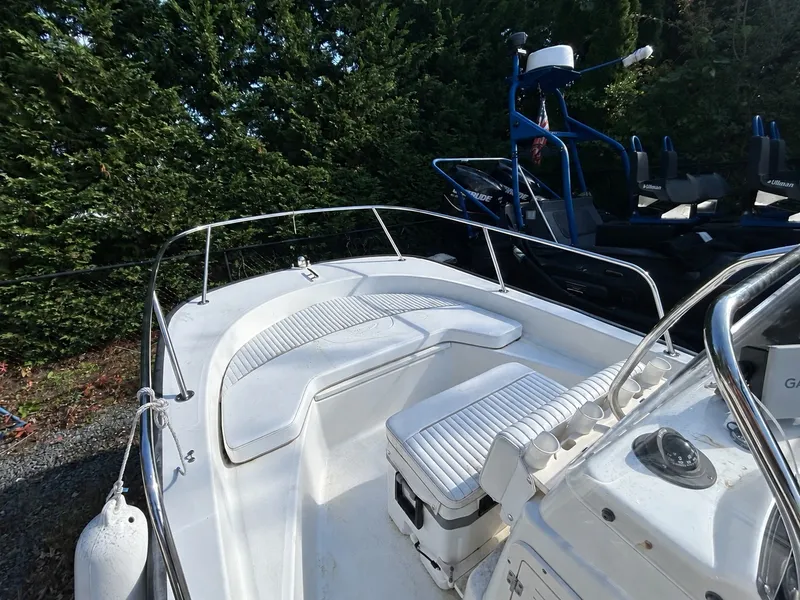 Slide: The Image of The image shows the deck of a 2007 Boston Whaler 17 Montauk with white seating. - 2
