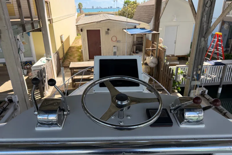Slide: The Image of Helm of 1995 Cabo 35 Express boat with steering wheel and controls. - 29