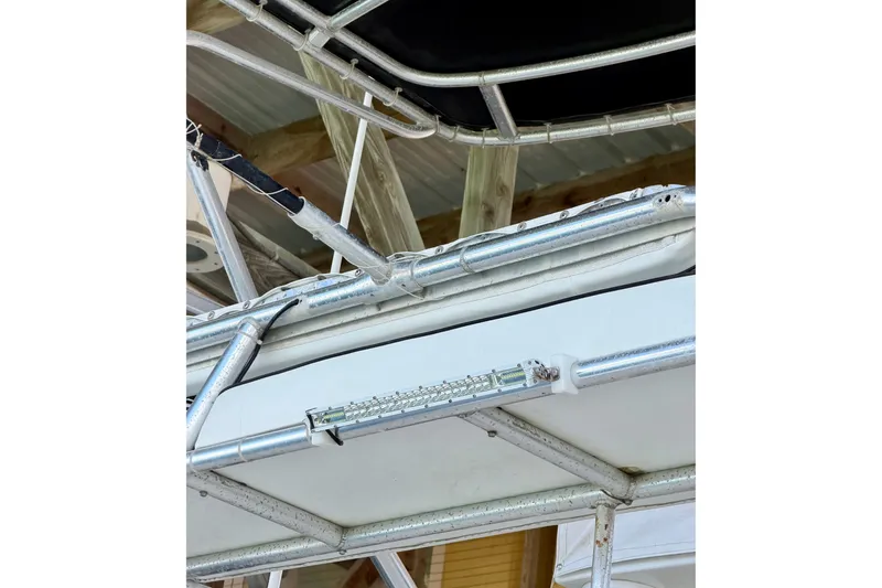 Slide: The Image of Metal framework of a 1995 Cabo 35 Express boat under a wooden roof. - 46