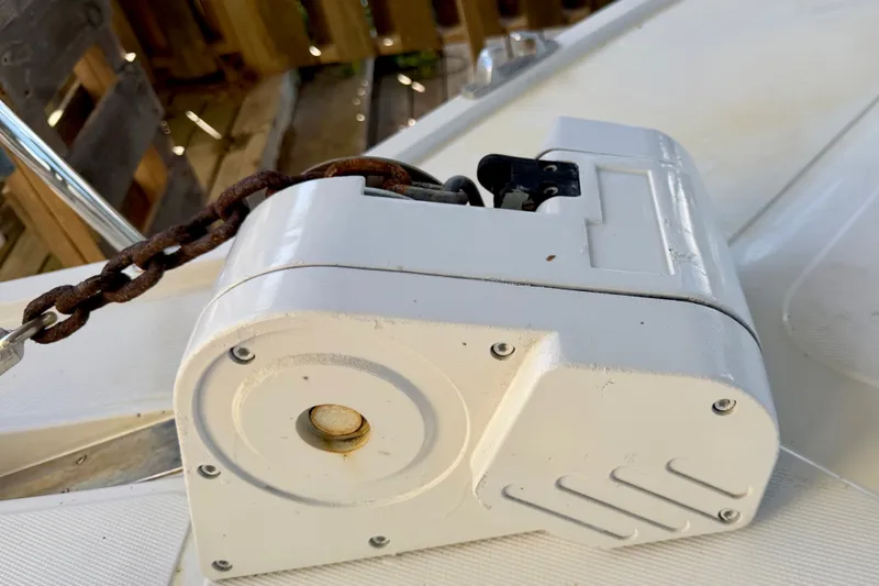 Slide: The Image of Anchor windlass on 1995 Cabo 35 Express boat deck with rusty chain. - 11