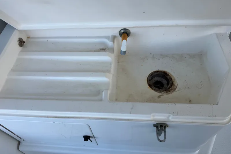 Slide: The Image of White sink on a 1995 Cabo 35 Express boat, showing faucet and drain. - 39