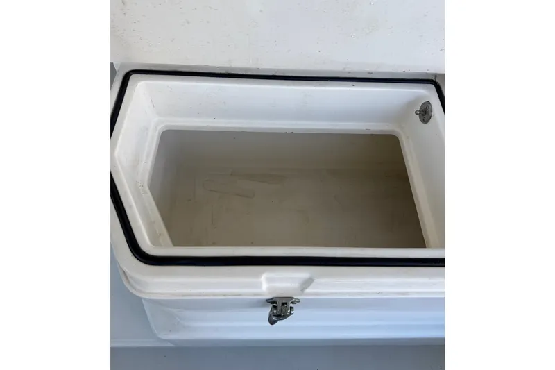 Slide: The Image of Open storage compartment on a 1995 Cabo 35 Express boat, featuring a white interior. - 40