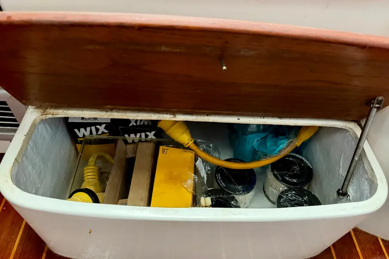 Slide: The Image of Storage compartment on 1995 Cabo 35 Express boat with cables and supplies. - 30