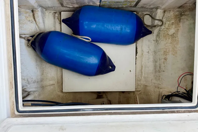 Slide: The Image of Storage compartment of 1995 Cabo 35 Express with blue boat fenders. - 43