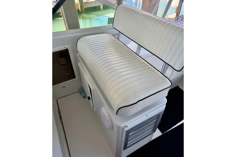 Slide: The Image of White cushioned seating on 1995 Cabo 35 Express boat interior. - 17
