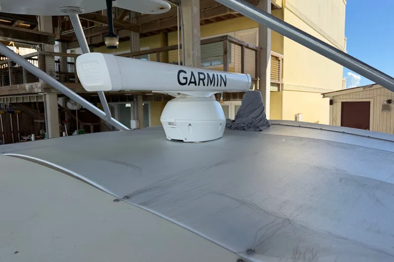 Slide: The Image of Garmin radar on 1995 Cabo 35 Express boat, docked near wooden structure. - 28