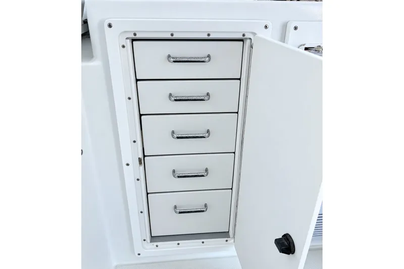Slide: The Image of White storage cabinet with five drawers on a 1995 Cabo 35 Express boat. - 19