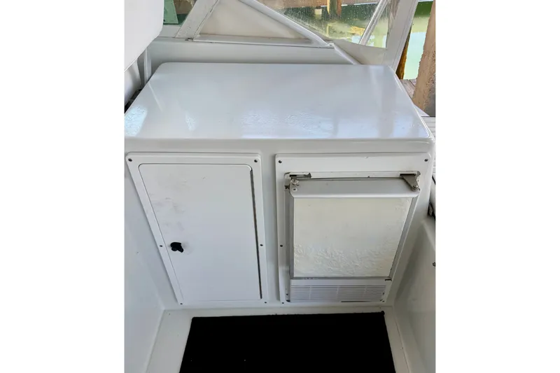 Slide: The Image of 1995 Cabo 35 Express boat interior with white storage compartments. - 18