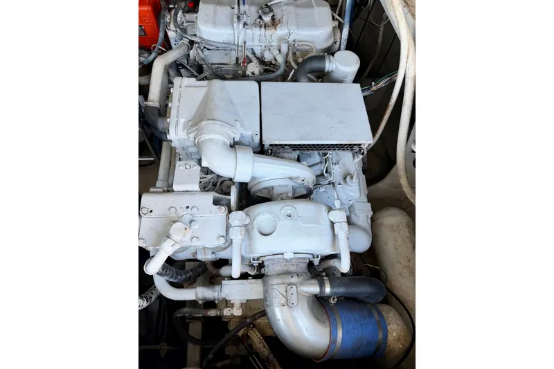 Slide: The Image of Engine of a 1995 Cabo 35 Express boat, showcasing mechanical components and piping. - 36