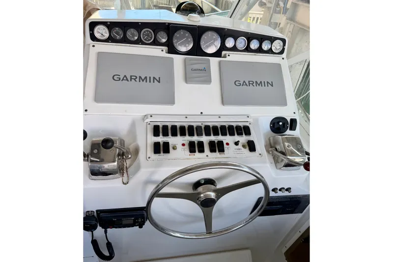 Slide: The Image of Helm of 1995 Cabo 35 Express with Garmin navigation and control panel. - 15