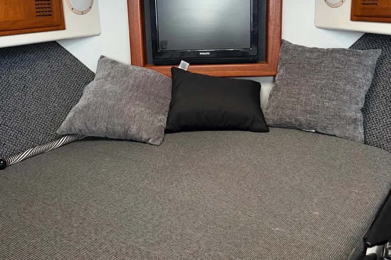 Slide: The Image of Cozy cabin interior of a 1995 Cabo 35 Express boat with pillows and a TV. - 24