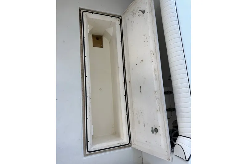 Slide: The Image of Open storage compartment on a 1995 Cabo 35 Express boat. - 42